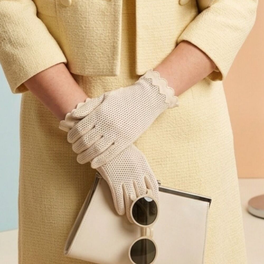 Vintage cream colored perforated gloves scalloped edges.